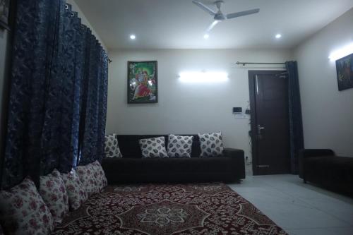 a living room with a couch and a window at Koushalaya Heights Retreat in Batoti