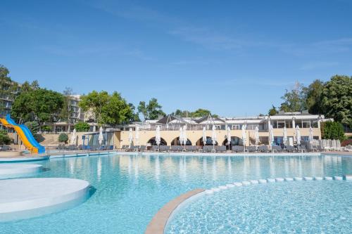 a swimming pool at a resort with a water slide at Safir Blue Resort in Saturn