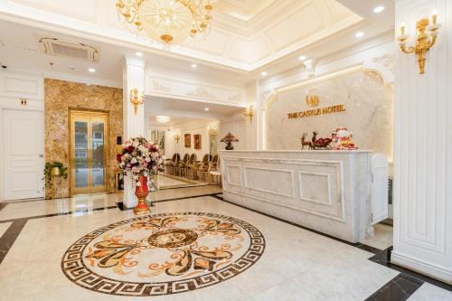 a large lobby with a fireplace and a large rug at Delina Castle Coffee & Hotel in Hanoi