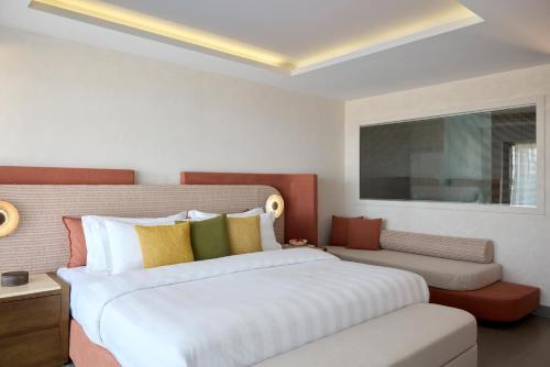 a bedroom with a large white bed and a window at Boutique 5 Hotel & Spa - Adults Only in Kiotari