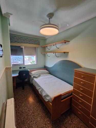 a bedroom with a bed and a desk in it at Ca La Solé in Vinarós