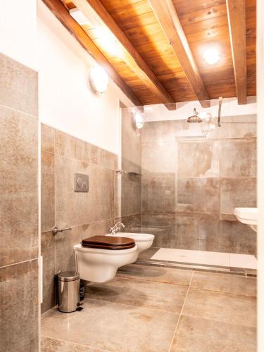 a bathroom with a toilet and a sink at Hotel D H Lawrence in Cagliari