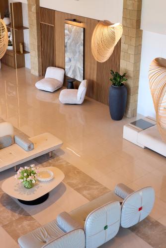 a lobby with couches and tables in a building at Boutique 5 Hotel & Spa - Adults Only in Kiotari