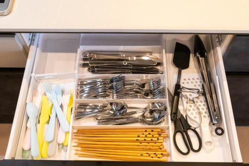 a drawer full of utensils in a cabinet at The SKY in Sapporo