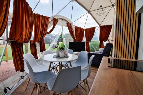 a room with a table and chairs and a large window at Holiday Park Zator in Zator