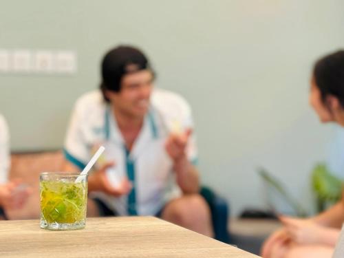 a man sitting at a table with a drink at The People - Paris Bercy in Paris