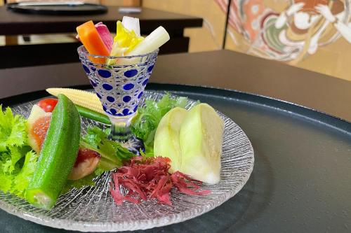 a plate of food with a salad and a drink at 高野山 宿坊 総持院 -Koyasan Shukubo Sojiin- in Koyasan