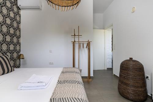 a bedroom with a bed and a cross on the wall at Villa Ikaros in Agia Triada