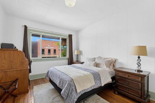a bedroom with a bed and a dresser and a window at The Loft in Whitefish