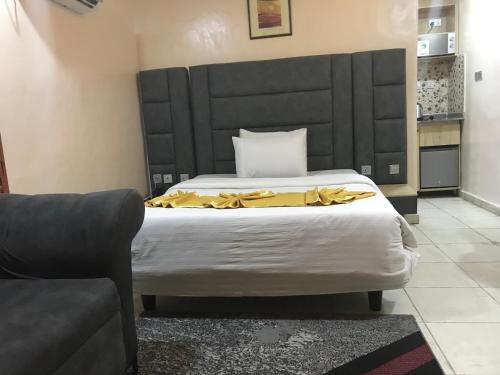 a bedroom with a bed with a yellow blanket on it at Homegate Resort in Araromi