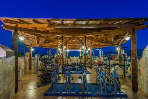 a wooden pavilion with bikes parked under it at Gaia Garden in Kos