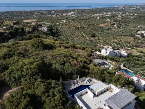 an aerial view of a house with a swimming pool at Villa Ikaros in Agia Triada