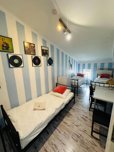 a room with two beds and a table with chairs at AB Hostel in Warsaw