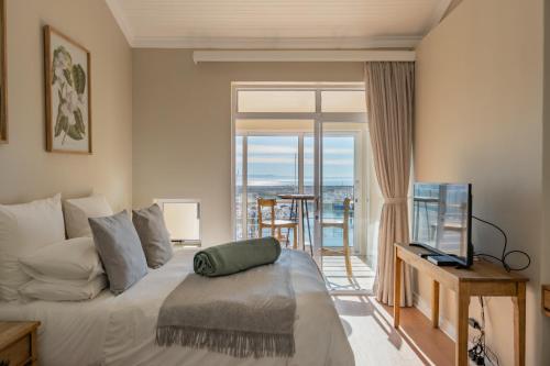 a bedroom with a bed and a view of the ocean at 9 Quarter Deck in St Francis Bay