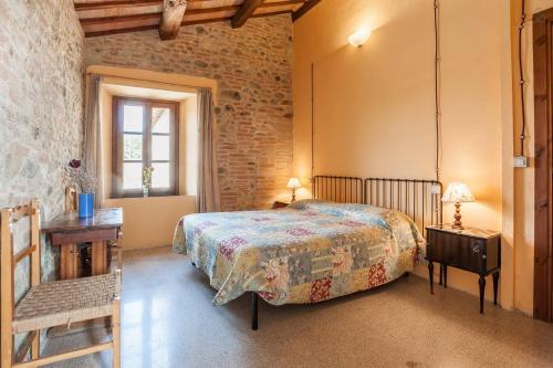 a bedroom with a bed and a table and a chair at Perugia Farmhouse in Perugia