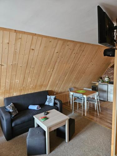a living room with a couch and a table at Pokoje gościnne Zosia in Kościelisko