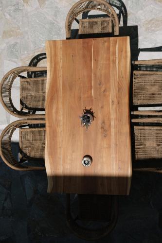 a wooden table with a spider on top of it at Naxos Finest Villa with Private Pool and Hot Tub at MIKRI VIGLA, Naxos in Mikri Vigla