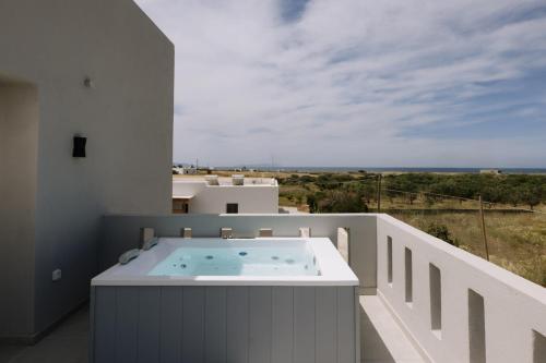 a hot tub on the balcony of a house at Naxos Finest Villa with Private Pool and Hot Tub at MIKRI VIGLA, Naxos in Mikri Vigla