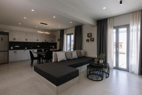a living room with a couch and a table at Naxos Finest Villa with Private Pool and Hot Tub at MIKRI VIGLA, Naxos in Mikri Vigla
