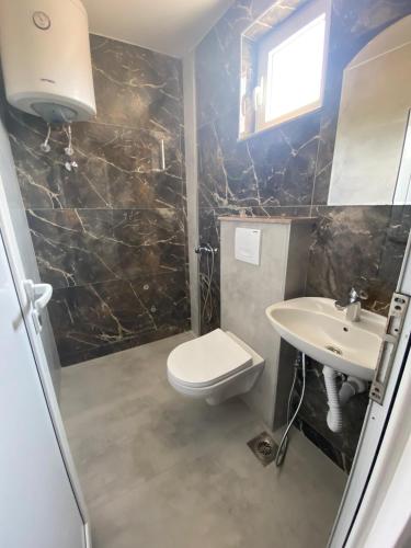 a bathroom with a toilet and a sink at Apartments Beho in Ulcinj