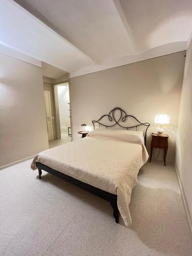 a bedroom with a bed and two tables and two lamps at Casa Edvige Suite in Monteveglio