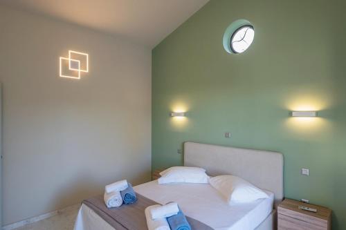 a bedroom with a bed with two towels on it at Apartment inside Villa Daniela-Elegant & Luxury Style-Private Pool in Schinias