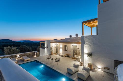 a villa with a swimming pool at night at Alkema Horizon in Philotium