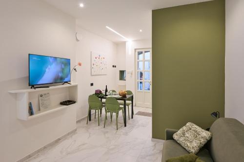 a living room with a table and a television at Nice Stresa - Appartamento Isola Bella in Stresa