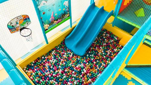 a slide in a pool of balls at Hotel Continental in Golden Sands