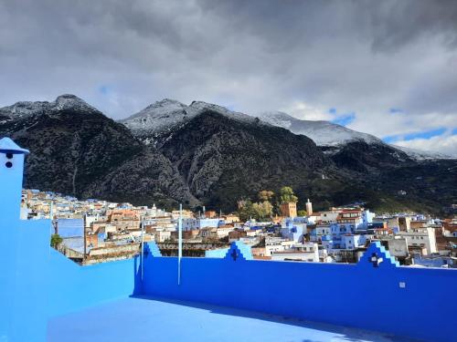 a view of a city with mountains in the background at DAR Dunia Panoramic terrace in Chefchaouene