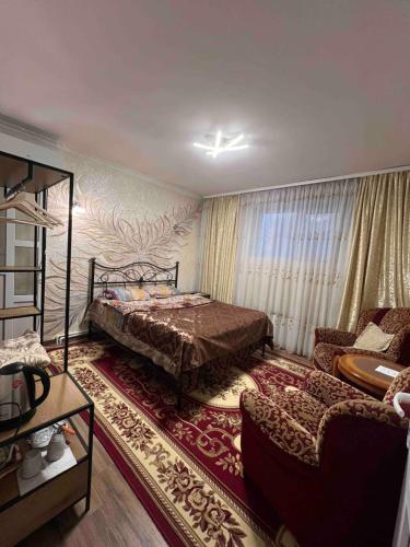 a bedroom with a bed and a couch at Golden Rose in Chişinău