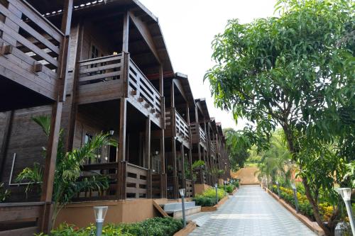 a building with a walkway in front of it at Axiom Resorts Luxury Cottages, Arambol in Arambol