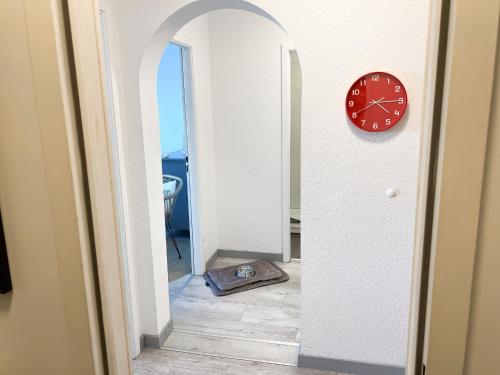 a clock and a mirror in a hallway at Apartment Seesrauschen für 2-4 Personen mit Pool in Dahme