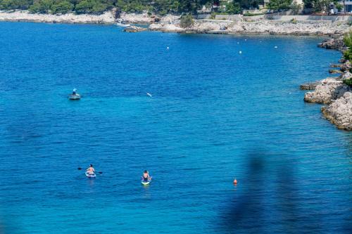 three people swimming in a large body of water at Villa Lavanda in Primošten