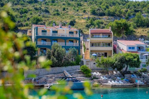 a house on a hill next to a body of water at Villa Lavanda in Primošten