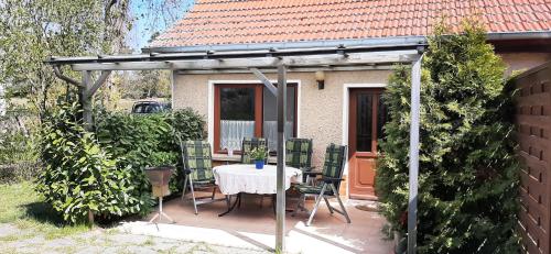 a pergola with a table and chairs on a patio at Ferienhaus Neela in Plau am See