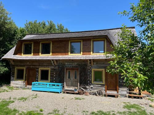 a log cabin with a blue front porch at Breb 220D glamping in Breb