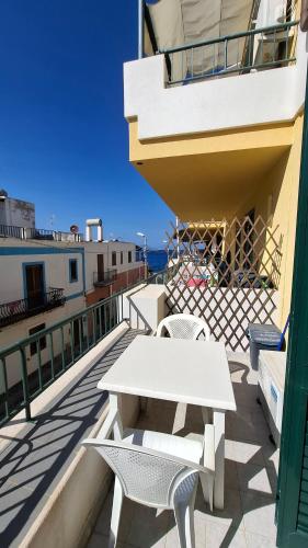 a table and chairs on the balcony of a building at CannetoMare in Canneto