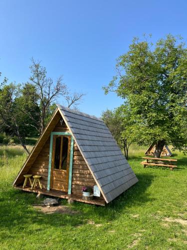 a small wooden cabin in a field of grass at Breb 220D glamping in Breb