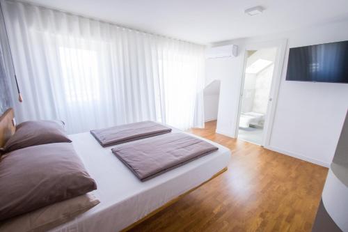 a bedroom with a bed and a large window at GuestHouse Malizia in San Benedetto del Tronto