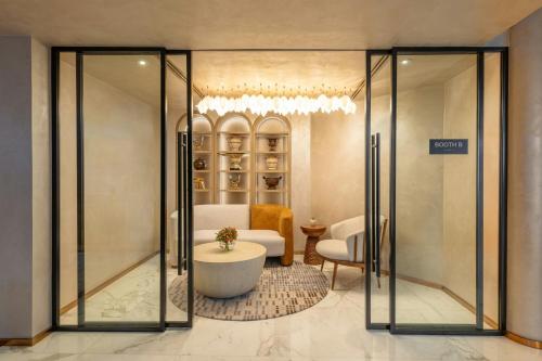 a hotel room with a lobby with a glass door at Sheraton Jumeirah Beach Resort in Dubai