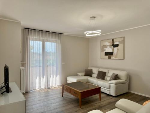 a living room with a couch and a coffee table at 1Dest - Le Ginestre Serenity Home in Riva del Garda