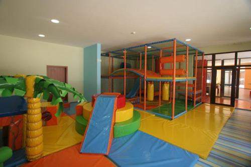 a childrens play room with a playground with a slide at Seaview Young Family - Семейство на Черно море in Aheloy