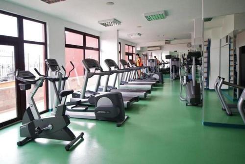 a gym with a row of treadms and elliptical machines at Seaview Young Family - Семейство на Черно море in Aheloy