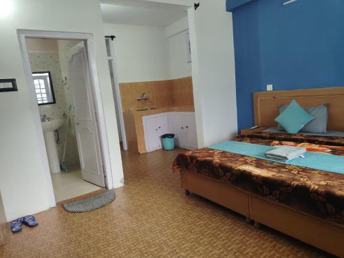 a bedroom with a bed and a bathroom at Check-in & Chill in Dharamshala