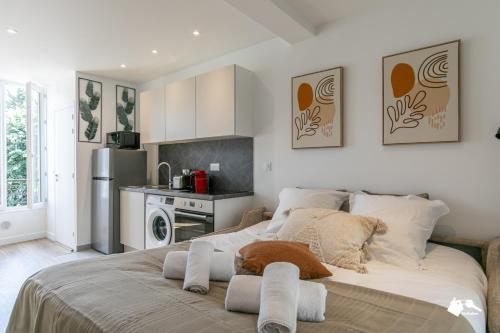 une chambre avec un lit avec des serviettes dessus dans l'établissement MBA - Diderot 3 - Splendide Appartement, à Montreuil