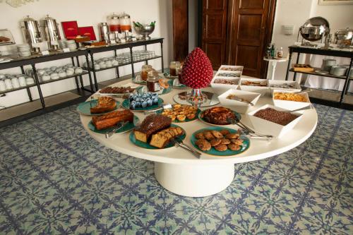 a table filled with different types of pastries and desserts at Hotel Chiaia Di Luna in Ponza