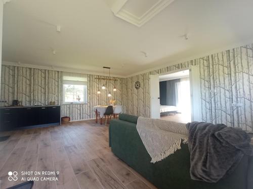a living room with a couch and a table at Agroturystyka Renatka 