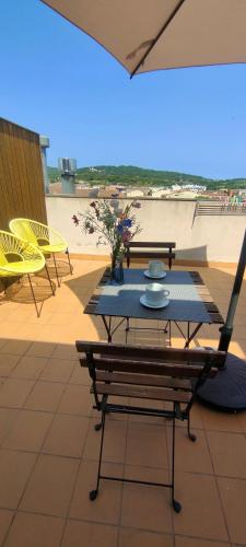 a patio with a table and chairs on the beach at Apartamento Loft Mar&Pol in Palafrugell