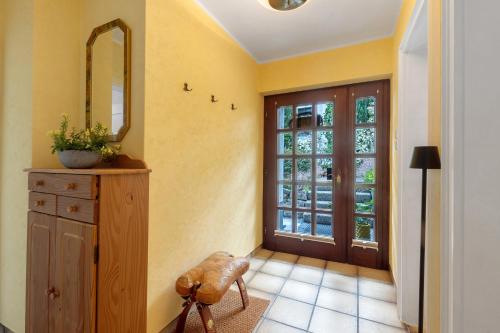 a hallway with a mirror and a dresser and a door at Schwalbennest in Lennestadt